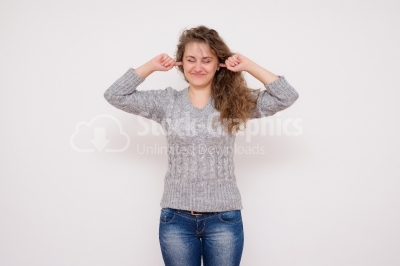  Woman closing her ears with fingers.