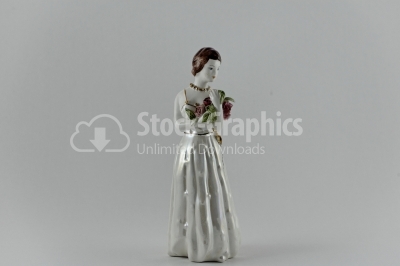 Antique female porcelain figurineon white