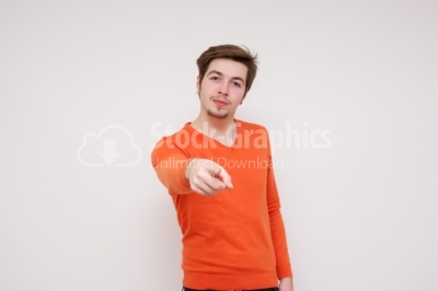 Attractive model pointing to camera on white background stock ph