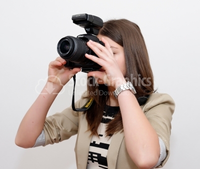 Beautiful woman taking a photo with a camera on a white backgrou