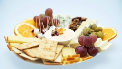 Cheese plates served with grapes, crackers and nuts