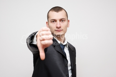 Close-up of a businessman gesturing thumbs down sign