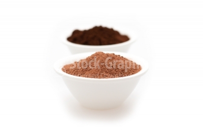 Cocoa powder and ground coffe in two white bowls