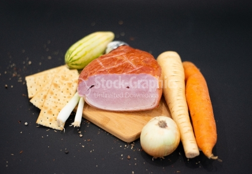 Cutting board with lots of vegetables and Smoked Prague Ham