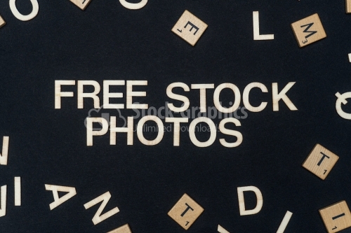 FREE STOCK PHOTOS word written on dark paper background. FREE STOCK PHOTOS text for your concepts