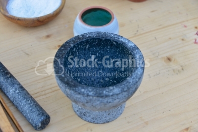 Granite mortar sitting on a wood table