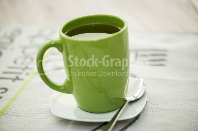 Green cup with tea