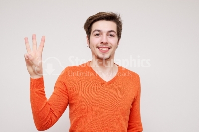Handsome young man showing fingers (isolated on white background