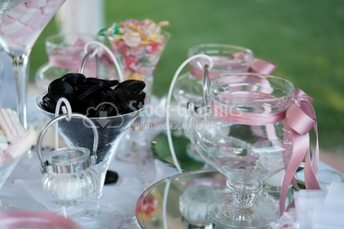 Italian candy bar with licorice snails and many glasses with pink ribbons