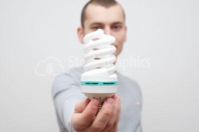 Man holding fluorescent light bulb in hand