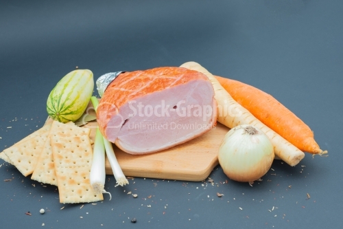 Nice wooden cutboard with smoked ham and vegetables
