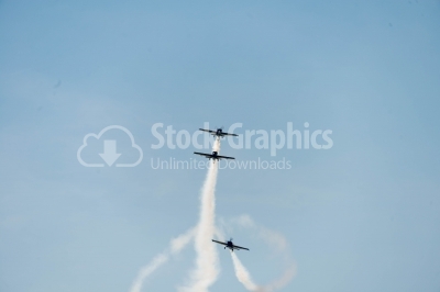 Propeller planes exercising air stunts