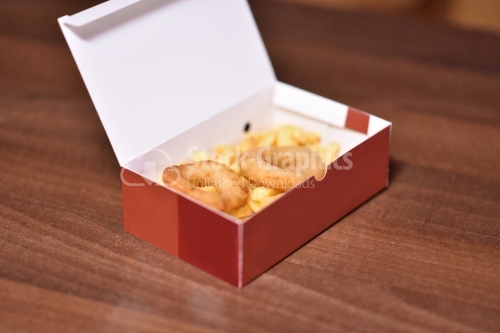 Rounds of onion and fries in a red cardboard box on the wooden table