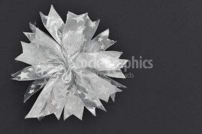 Silver bow decorations on a dark background