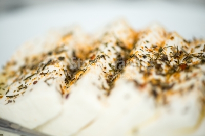 Slices of creamy cheese with aromatic herbs