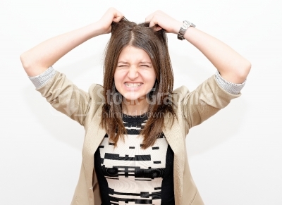 Stressed businesswoman ruffles her hair