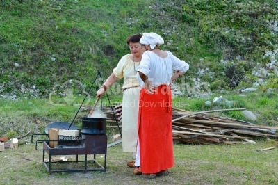 Two womens cooking food on a medieval festival