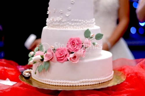 White wedding cake with roses marzipan ornament