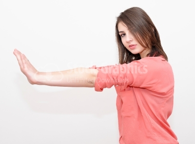 Woman pushing something imaginary - isolated over a white backgr