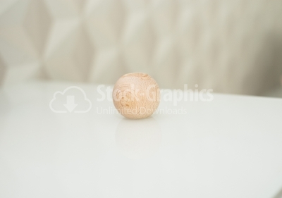 Wood ball on glass table