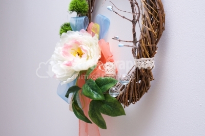 Wooden wreath with artificial flowers