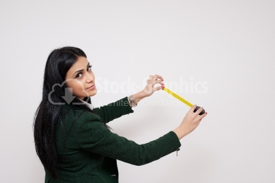 Young and beautiful girl with the measuring tape isolated on whi