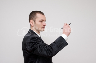 Young businessman drawing with a marker