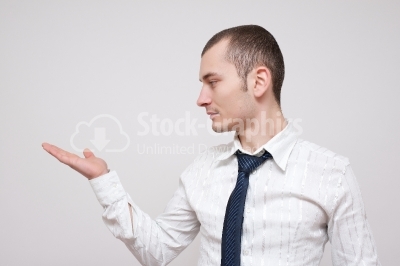 Young businessman looking at his hand