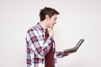 Young guy holding a computer on his hand