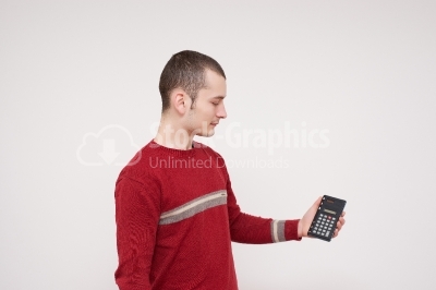 Young man holding a calculator in his hands stock photo