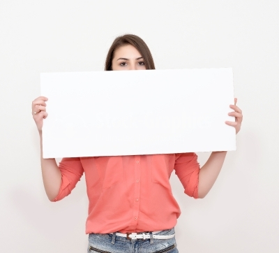 Young woman with an empty sheet of paper half covering face stoc