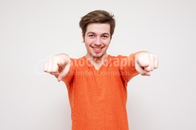 Attractive model pointing to camera on white background stock ph
