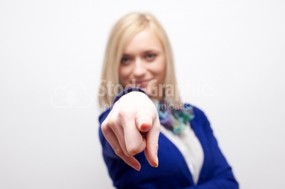 Attractive young woman pointing and smiling