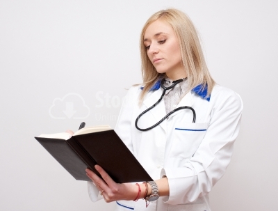 Beautiful female doctor holding her agenda
