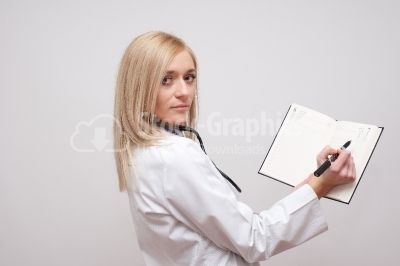 Beautiful female doctor holding her agenda