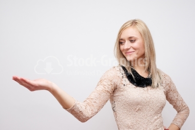 Beautiful girl gives a presentation, holding something in handso