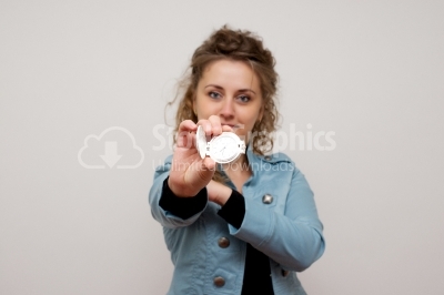 Beautiful woman holding clock