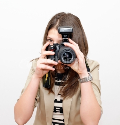 Beautiful woman taking a photo with a camera on a white backgrou