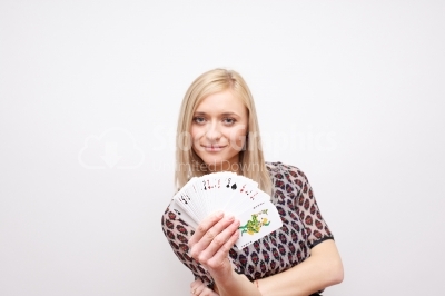 Beautiful young woman holding poker cards