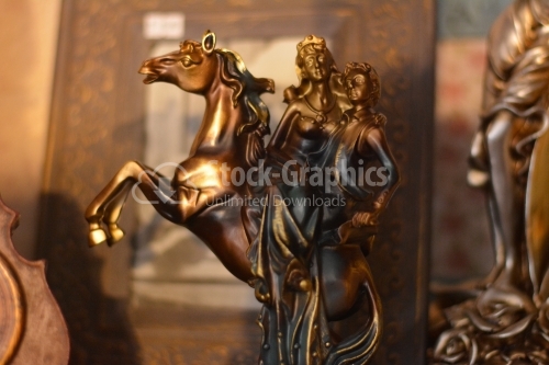Bronze statue with the prince and princess on the horse.