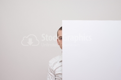 Businessman hiding after a placard