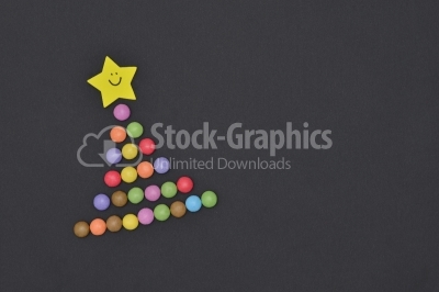 Candies Christmas tree with smiley face on star