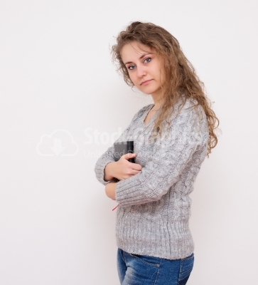 Casual young woman looking at camera with arms crossed and satis