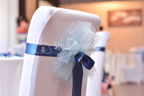 Chair details with blue and white bows for a wedding day
