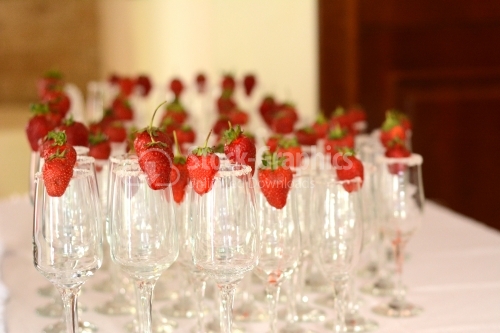 Champagne glasses with fresh strawberries waiting to be filled
