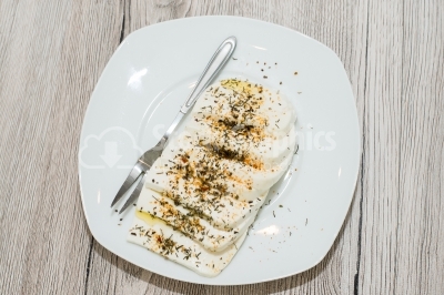 Cheese with herbs on white dish
