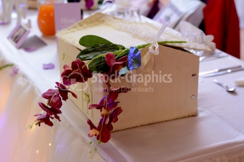 Chest decorated with fake orchids for gifts and money at the wedding.