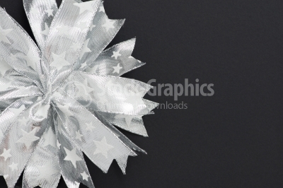 Christmas background. Silver bow decorations on a dark backgroun