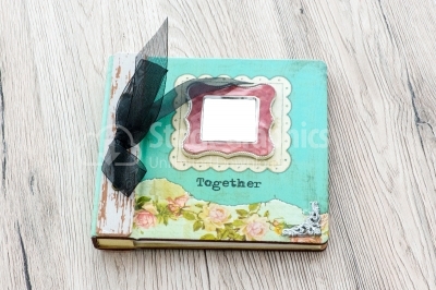 Closes vintage photo album on a wood background