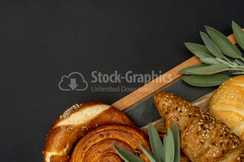 Cooking board with breads on a dark background